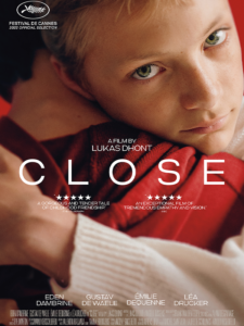 Close poster featuring a young man embracing another young man and looking directly into the camera.